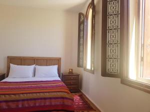 A bed or beds in a room at Riad Inspira