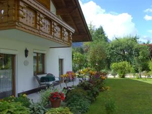 eine Veranda eines Hauses mit Stühlen und Blumen in der Unterkunft Landhaus Doris in Leutasch