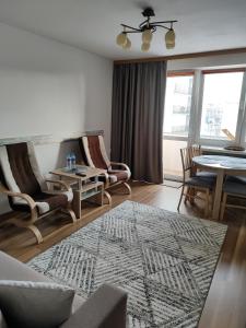 sala de estar con sofá, sillas y mesa en Apartament Praski 5 minut od metra i starego miasta spacerem do zoo i Konesera, en Varsovia