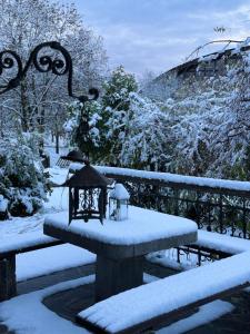 einen schneebedeckten Tisch neben einem Zaun in der Unterkunft Alice Chalet Bled - Adults only in Bled