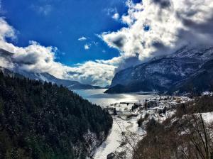 莫尔韦诺Garnì Lago Alpino的享有山谷中小镇的景色,山谷中被雪覆盖着山脉