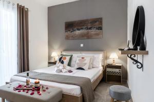 a bedroom with a bed with a tray of food on it at MarGio Bay in Limenas