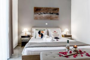 a bedroom with two beds with a tray of roses at MarGio Bay in Limenas