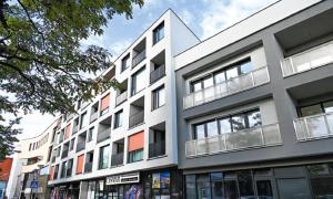 un gran edificio blanco con balcones en una calle en Apartment Paulínska, en Trnava