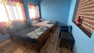 a room with two beds and a couch in it at AG Cottage Vattakanal in Kodaikānāl