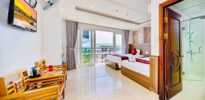 a hotel room with two beds and a balcony at Dubai Nha Trang Hotel managed by HT in Nha Trang