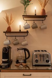 a kitchen counter with a toaster and a coffee maker at Auberge Old Chelsea in Chelsea