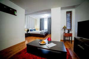 a living room with a couch and a coffee table at Velinov Boutique Hotel in Bansko