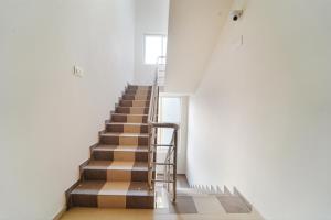 a staircase in a building with a metal railing at FabHotel Saro Sri Residency in Coimbatore