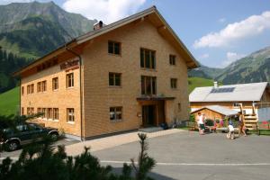 a large building with people standing outside of it at Villa Natur in Schröcken