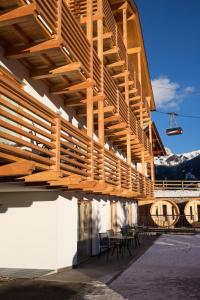 a wooden deck on the side of a building at Chalet Marcora in Campitello di Fassa