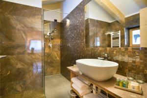 a bathroom with a sink and a shower at Chalet Marcora in Campitello di Fassa