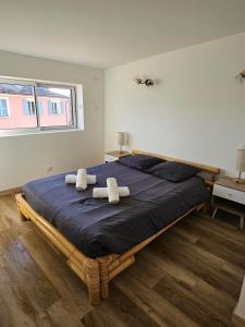 a bedroom with a large bed with two towels on it at Sur les toits in Draguignan