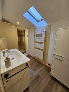 a bathroom with a sink and a skylight at Sur les toits in Draguignan