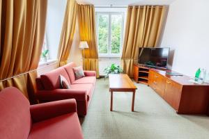 A television and/or entertainment centre at Spa & Wellness Hotel Olympia Marienbad