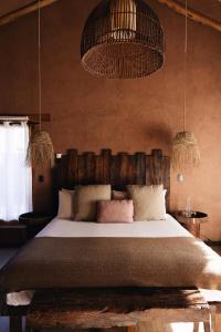 A bed or beds in a room at Our Habitas Atacama