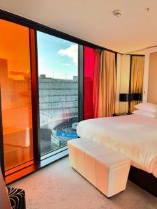 a bedroom with a large window with a view at Crowne Plaza Manchester City Centre, an IHG Hotel in Manchester