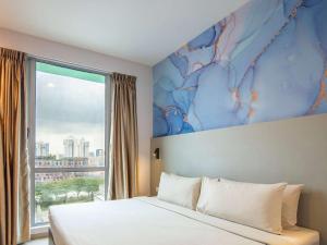 Rúm í herbergi á ibis Styles Singapore Albert