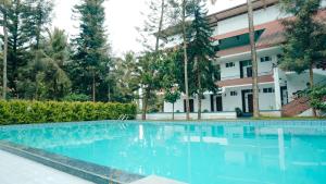 una piscina vuota di fronte a un edificio di Mazra Retreat, Coorg Kushālnagar a Kushalnagar