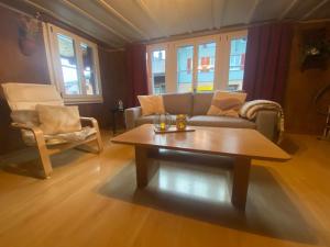 a living room with a couch and a coffee table at Cosy apartment in heritage protected swiss chalet in Matten