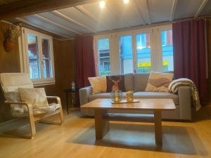 a living room with a couch and a coffee table at Cosy apartment in heritage protected swiss chalet in Matten