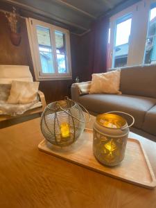 two candles on a tray on a table in a living room at Cosy apartment in heritage protected swiss chalet in Matten