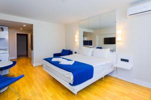 a bedroom with a large bed and a table and chairs at VIP APARTmENTS N10 in Batumi