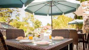 una mesa con platos de comida y una sombrilla en Hotel Roosevelt, en Punta del Este