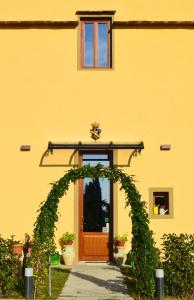 une arche devant un bâtiment jaune avec une porte dans l'établissement Visconte Apartment, à Florence