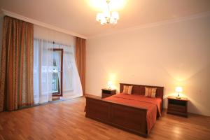 a bedroom with a bed and two lamps on two tables at Slunecni Lazne Apartments in Karlovy Vary