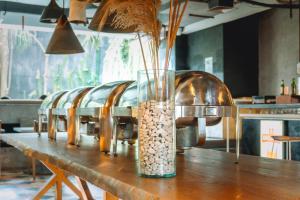 a vase filled with rocks sitting on top of a table at IKOSHAROLD Suites Seminyak in Seminyak