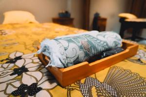 a box of towels sitting on top of a bed at IKOSHAROLD Suites Seminyak in Seminyak