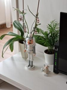 a figurine on a table next to a plant at NEW - Frendly Luxury Apartment Franka Zagreb in Zagreb