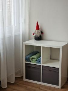 a white shelf with a gnome hat on top of it at NEW - Frendly Luxury Apartment Franka Zagreb in Zagreb