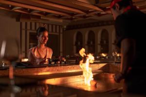 a woman in a bathtub with a fire in it at Steigenberger Golf Resort El Gouna in Hurghada