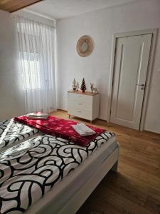 a bedroom with a bed with a black and white comforter at Natalia in Leoben