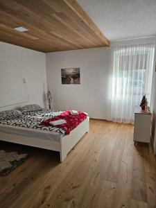 a bedroom with a bed and a large window at Natalia in Leoben