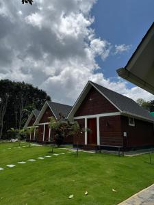 a row of houses on a green lawn at Wild Part in Sultan Bathery