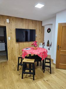 a dining room with a table and a television at Natalia in Leoben