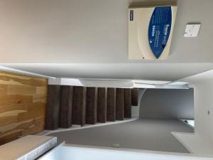 a shelf in a room with a bed in it at Bayside GuestHouse in Bournemouth