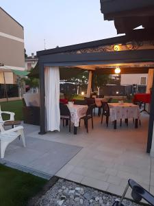 an outdoor patio with tables and chairs and a pavilion at Mums b and b - colonnina elettrica in Vicenza