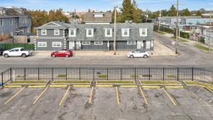 a parking lot with cars parked in front of a building at Sleeps 22-spacious Suites Near Fq W Pool in New Orleans