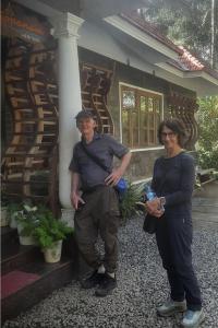 a man and a woman standing in front of a house at Sopanam Heritage Thekkady in Thekkady