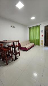 uma sala de estar com uma mesa e cadeiras e um sofá em Apartamentos sophia em San Andrés