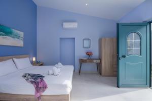 a blue bedroom with a bed and a blue door at M City Apartments 100m from the beach in Chania Town