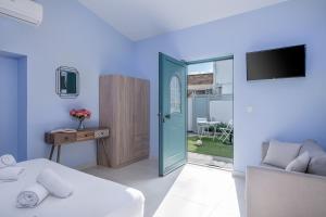 a bedroom with a bed and a sliding glass door at M City Apartments 100m from the beach in Chania Town