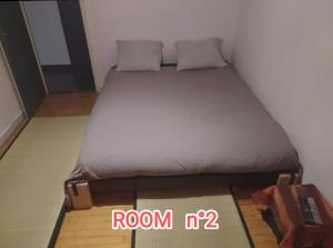 een slaapkamer met een bed en een kamer zonder bord bij Chambres dans appartement partagé in Grenoble