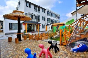 a group of plastic figurines in front of a building at Shanghai Chuxin Moshe B&B Disney Store in Shanghai