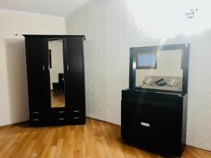 a black dresser with a mirror in a room at Anastasia in Mtskheta