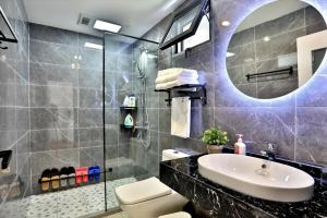 a bathroom with a sink and a mirror at Shanghai Chuxin Moshe B&B Disney Store in Shanghai